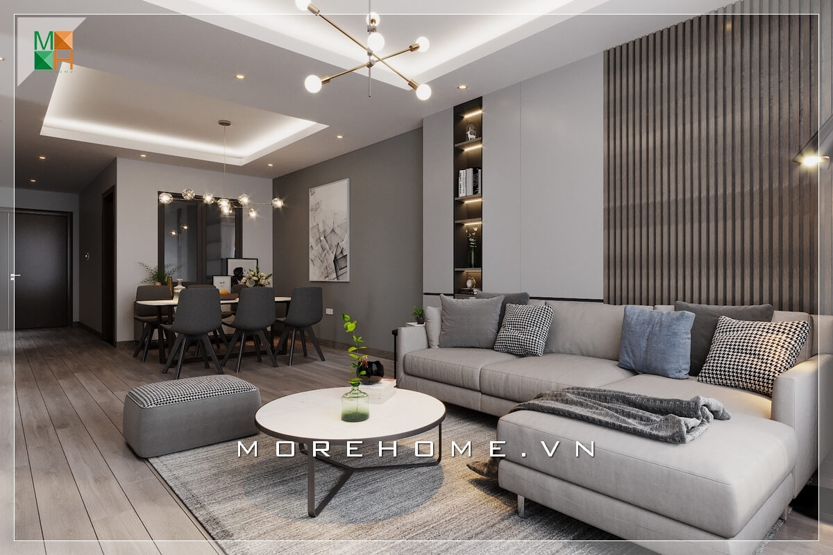 Phòng khách chung cư ấn tượng với sofa dáng góc hiện đại bọc vải màu ghi nhẹ nhàng, ấm cúng. Thiết kế nội thất